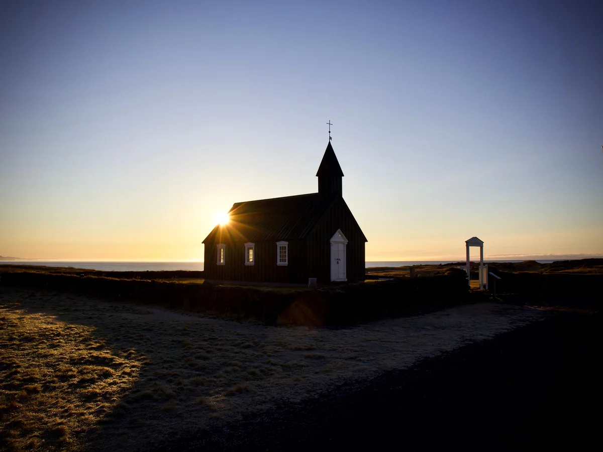 Budakirkja, the small black timber church at Budir, silhouetted at sunset